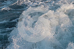 Foam wave trail behind ship, textured white water surface