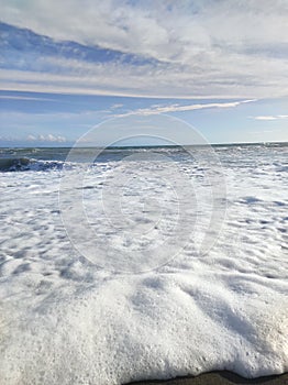 foam of waves. the froth of the beach waves are very much, then mysteriously disappear.