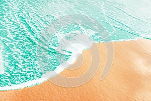Foamy clear sea wave rolling to pink sand shore beach. Aerial view from above. Beautiful tranquil idyllic ocean scenery. Tropical