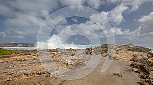 Foamy spray from storm waves crashing into Laie Point coastline at Kaawa on the North Shore of Oahu Hawaii USA