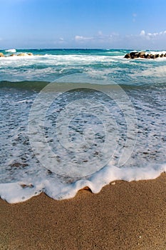 Foamy water on beach photo