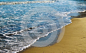 Foamy waves in blue sea