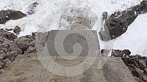 Foamy waves break rocks on beach of stormy Adriatic sea