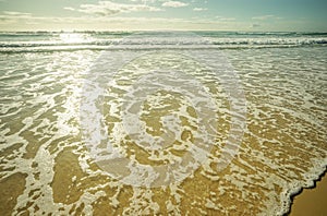 Foamy White Wash Crossing the Sandy Beach