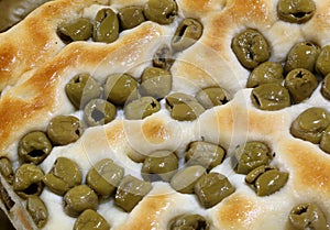focaccia with green olives for sale in a bakery