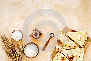 Focaccia ingredients. Wheat ears, flour, oil near bread on beige background top-down copy space