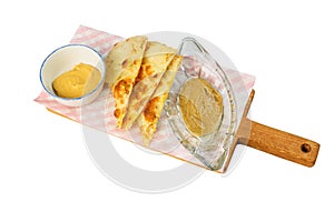 Focacha with sauce on a cutting Board on white background, isolated
