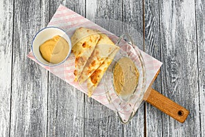 Focacha with sauce on a cutting Board on wooden background