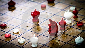 Focus at Agressive Red Horse figure, Thai Chess on Wood Board, T photo