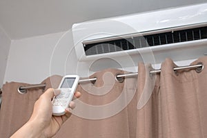 Focus ahead.Air condition control by using remote control and turn on the air conditioner at 25 degrees