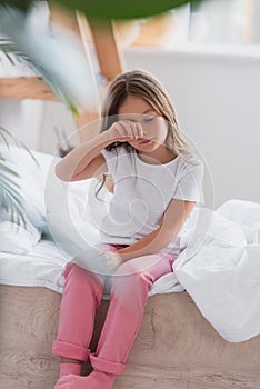 Focus of awakened girl in pajamas