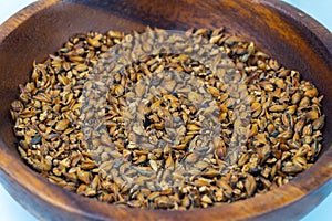 Focus on Barley grains in a wooden bowl