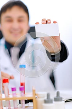 Focus on blank business card on hand of doctor