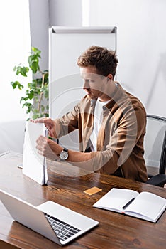 Focus of businessman holding papers near