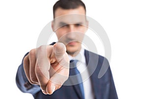 Focus on businessman index finger pointing at camera