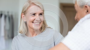 Focus on caregiver face female assisting patient listening older man