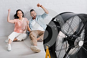 Focus of cheerful couple showing yeah