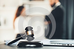 Focus closeup wooden gavel on blur background of legal team. Equilibrium