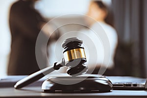 Focus closeup wooden gavel on blur background of legal team. Equilibrium