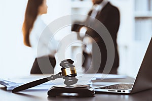 Focus closeup wooden gavel on blur background of legal team. Equilibrium