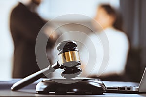 Focus closeup wooden gavel on blur background of legal team. Equilibrium