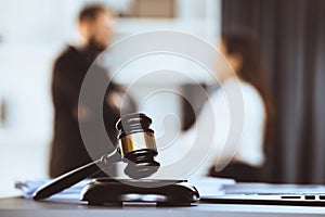 Focus closeup wooden gavel on blur background of legal team. Equilibrium