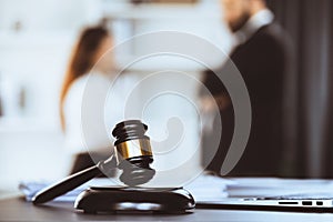 Focus closeup wooden gavel on blur background of legal team. Equilibrium