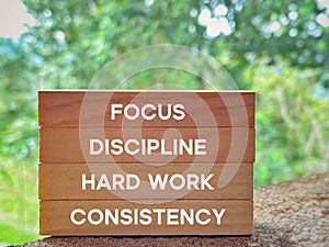 Focus discipline hard work consistency text on wooden blocks background. Inspirational and Motivational Concept.