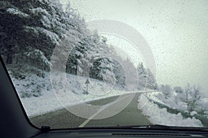 Focus On Drops On Windscreen Glass, On Background Snowscape