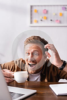 Focus of excited businessman looking at