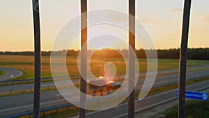 Focus on flyover guardrail safety wall parapet onto highway speedway road in countryside at sunset. Overpass overbridge