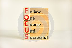 FOCUS follow one course until successful symbol. Concept words FOCUS follow one course until successful on block. Beautiful white
