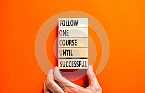 FOCUS follow one course until successful symbol. Concept words FOCUS follow one course until successful on wood block. Orange