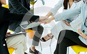 Focus on hands put together to show unity, power, professional teamwork in business corporation or collaboration. Diversity and