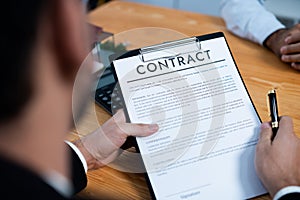 Focus house loan contract with blurred client review legal paper. Fervent