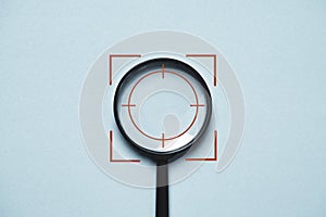 Focus icon inside of magnifier glass for concentrate with business objective goal and target on blue background and copy space