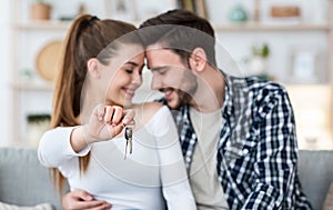 Focus on keyes. Happy couple and new apartment