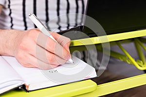 Focus on man's hand writing in diary