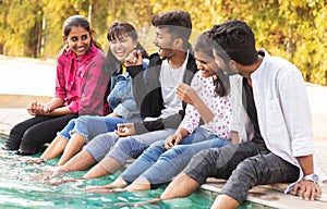 Focus on middle boy, Group of young millenials having fun and enjoying some good time near swimming pool - Concept of friendship, photo