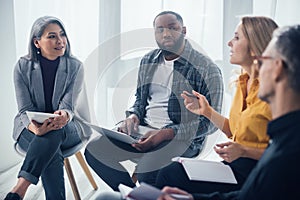 Focus of multicultural colleagues with gadgets