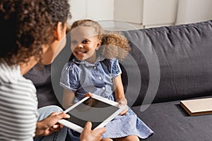 Focus of nanny holding digital tablet