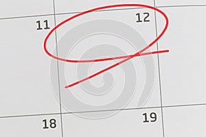 Focus on number 12 in calendar and empty red ellipse.