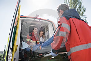Focus of paramedics carrying stretcher with