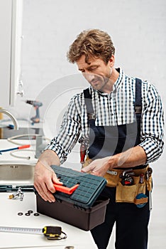 Focus of plumber in workwear opening