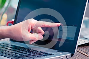 Focus on the point finger touching the laptop screen for inputting the network security key
