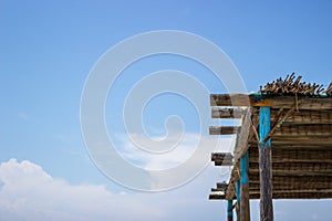 Focus on the reed pole for shade on the seashore. is a wonderful sunny day. Behind is a beautiful blue sky. Copy Space