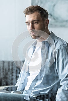 Focus of sad disabled man on wheelchair