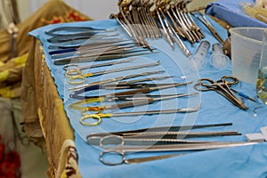 Focus at the scaples,the tools including scalpels, forceps and tweezers arranged on a table for a surgery