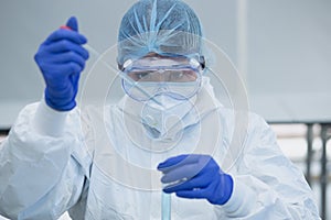 Focus on scientist holding test tubes COVID19