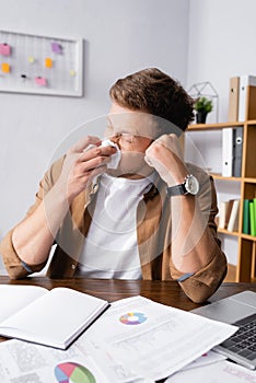 Focus of sick businessman holding napkin